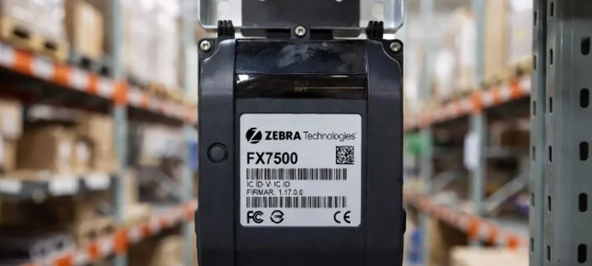 Zebra FX7500 RFID reader hardware showing FCC firmware labels in a warehouse logistics setting Zebra FX7500 RFID reader hardware showing FCC firmware labels in a warehouse logistics setting